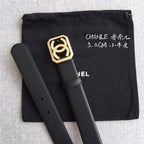 Dark leather belt with gold square logo buckle and rhinestone accents, folded with black pouch.