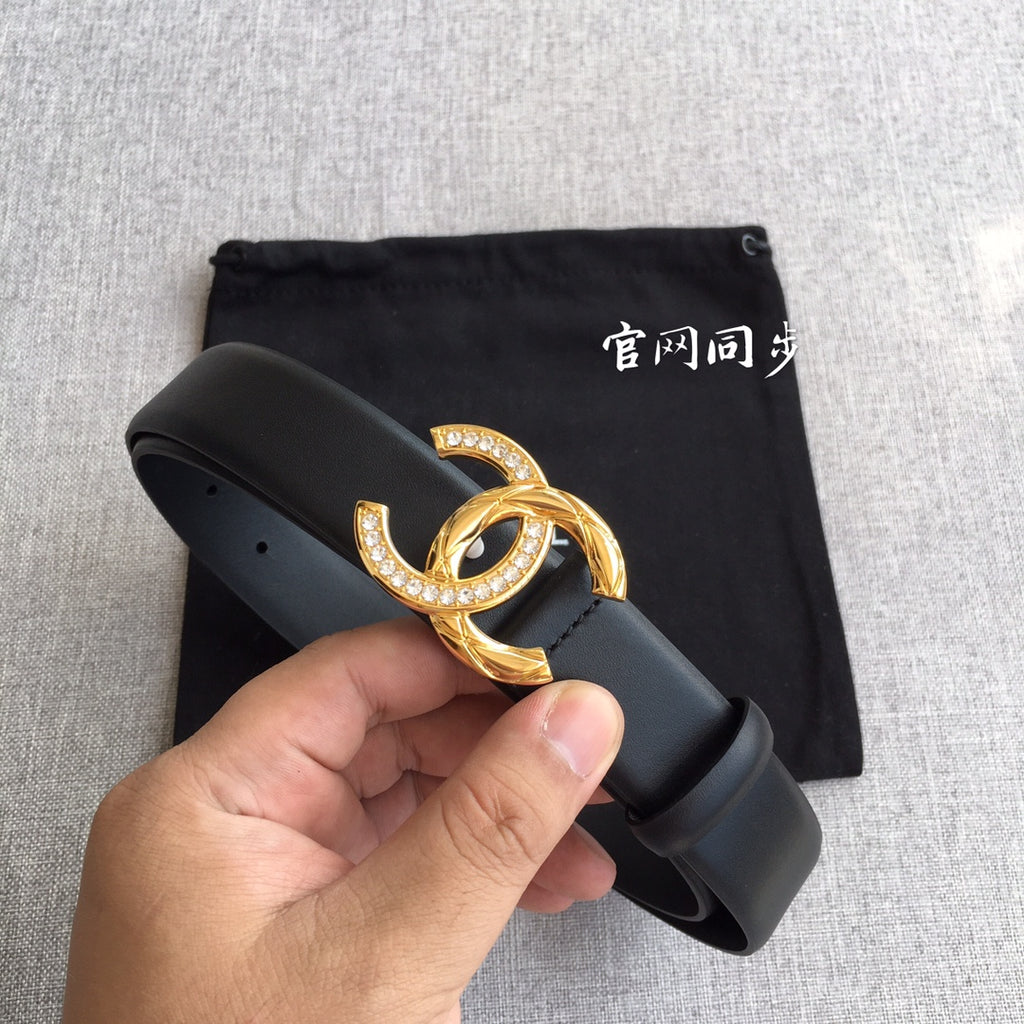 Chanel belt close-up: dark gray strap with gold rhinestone CC buckle