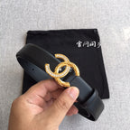 Chanel belt close-up: dark gray strap with gold rhinestone CC buckle