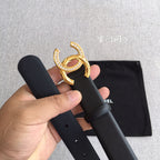 Chanel belt close-up: dark gray strap with gold and rhinestone CC buckle