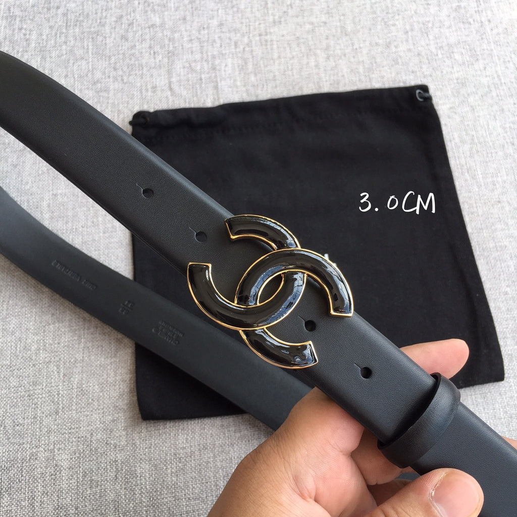 Dark leather belt with gold-tone interlocking C buckle and punched holes on strap.