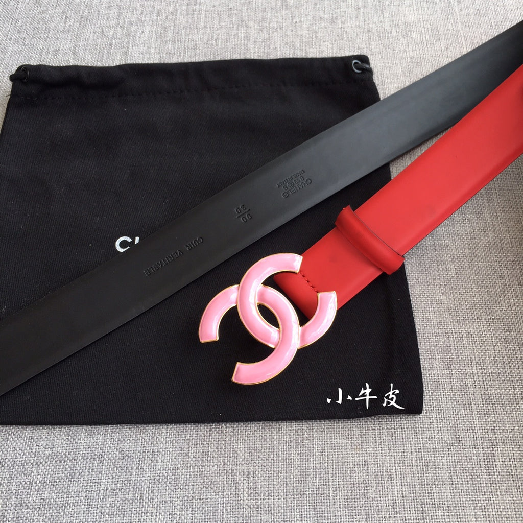 Red belt with pink CC buckle and red keeper, shown beside dark strap