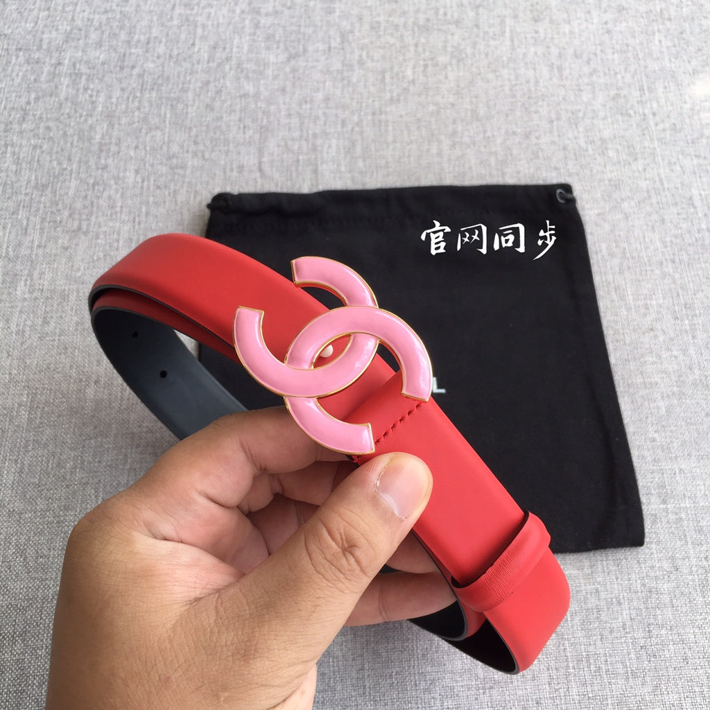 Red belt with pink CC buckle, shown in hand with black dust bag