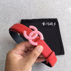 Red belt with pink CC buckle, shown in hand with black dust bag
