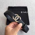 Chanel belt with dark leather strap and gold-tone buckle, shown with folded black pouch