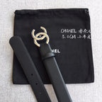 Chanel belt with dark leather strap and gold-tone logo buckle, paired with black pouch