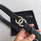 Chanel belt with dark black strap and gold-tone double-ring buckle, shown at angle