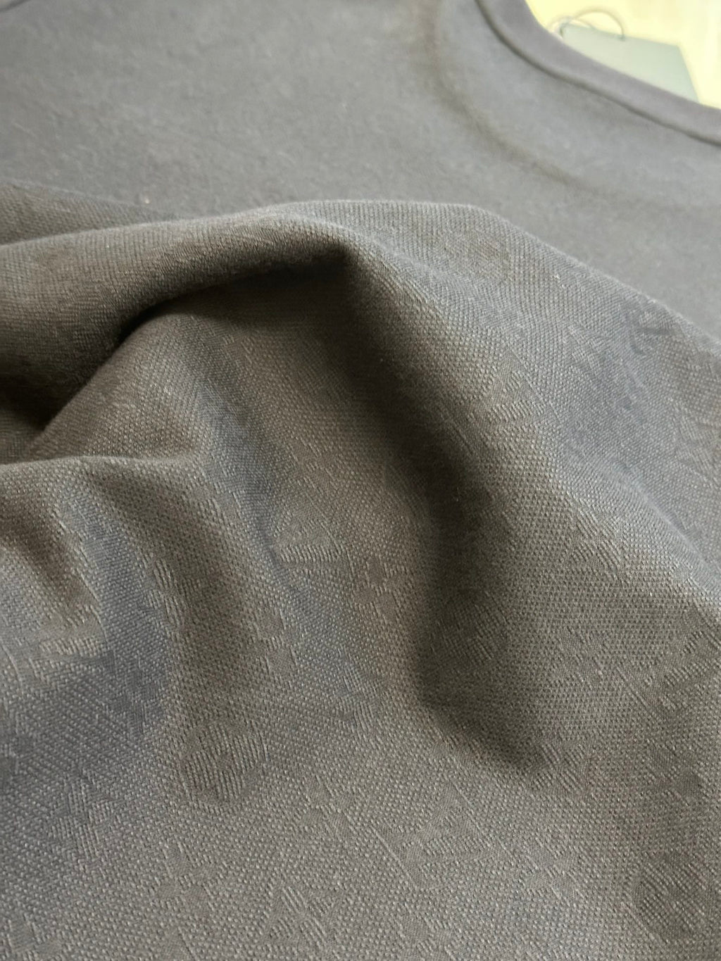 Charcoal T-shirt fabric close-up with textured weave
