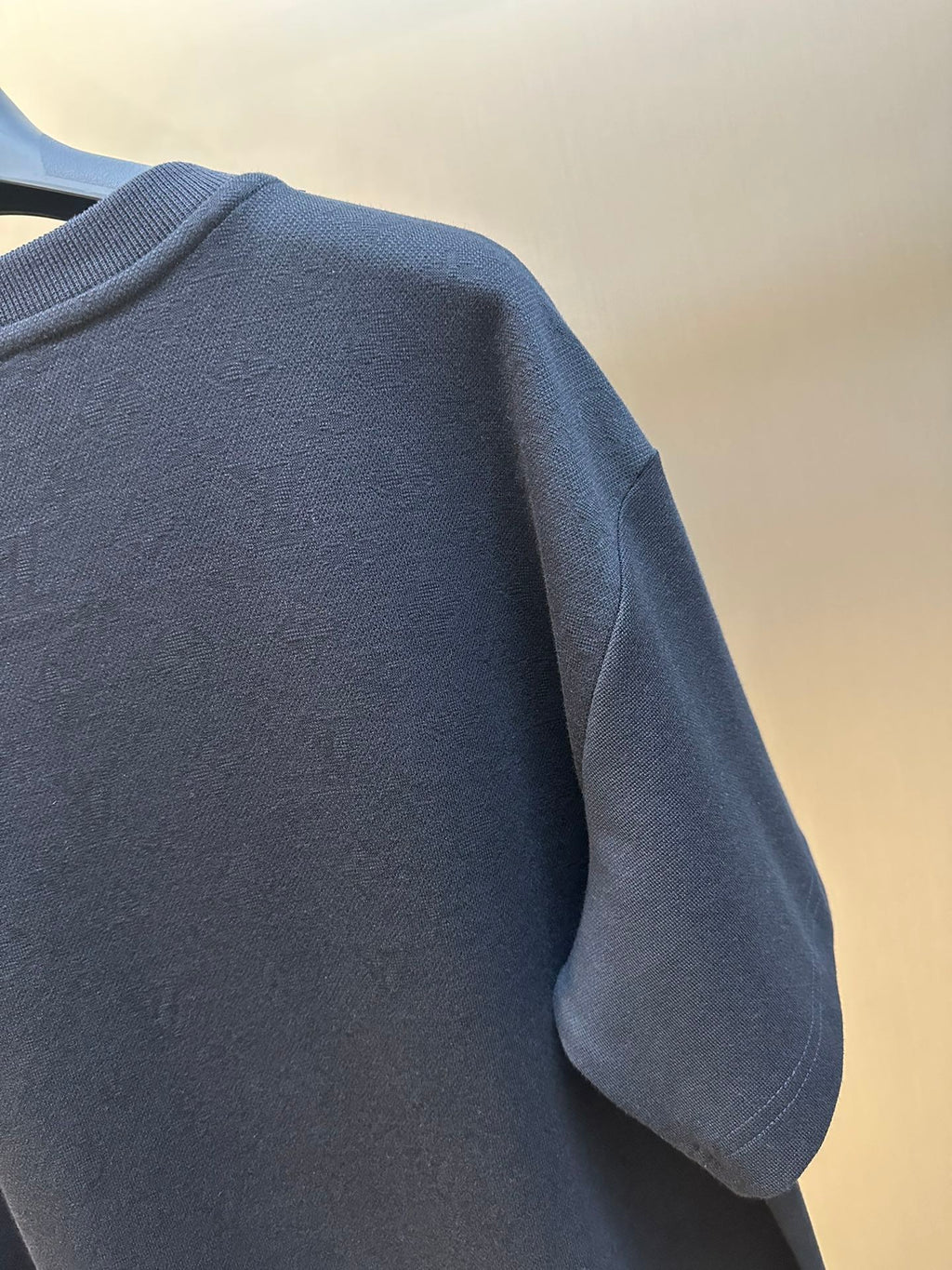 Louis Vuitton dark navy T-shirt sleeve and shoulder seam close-up