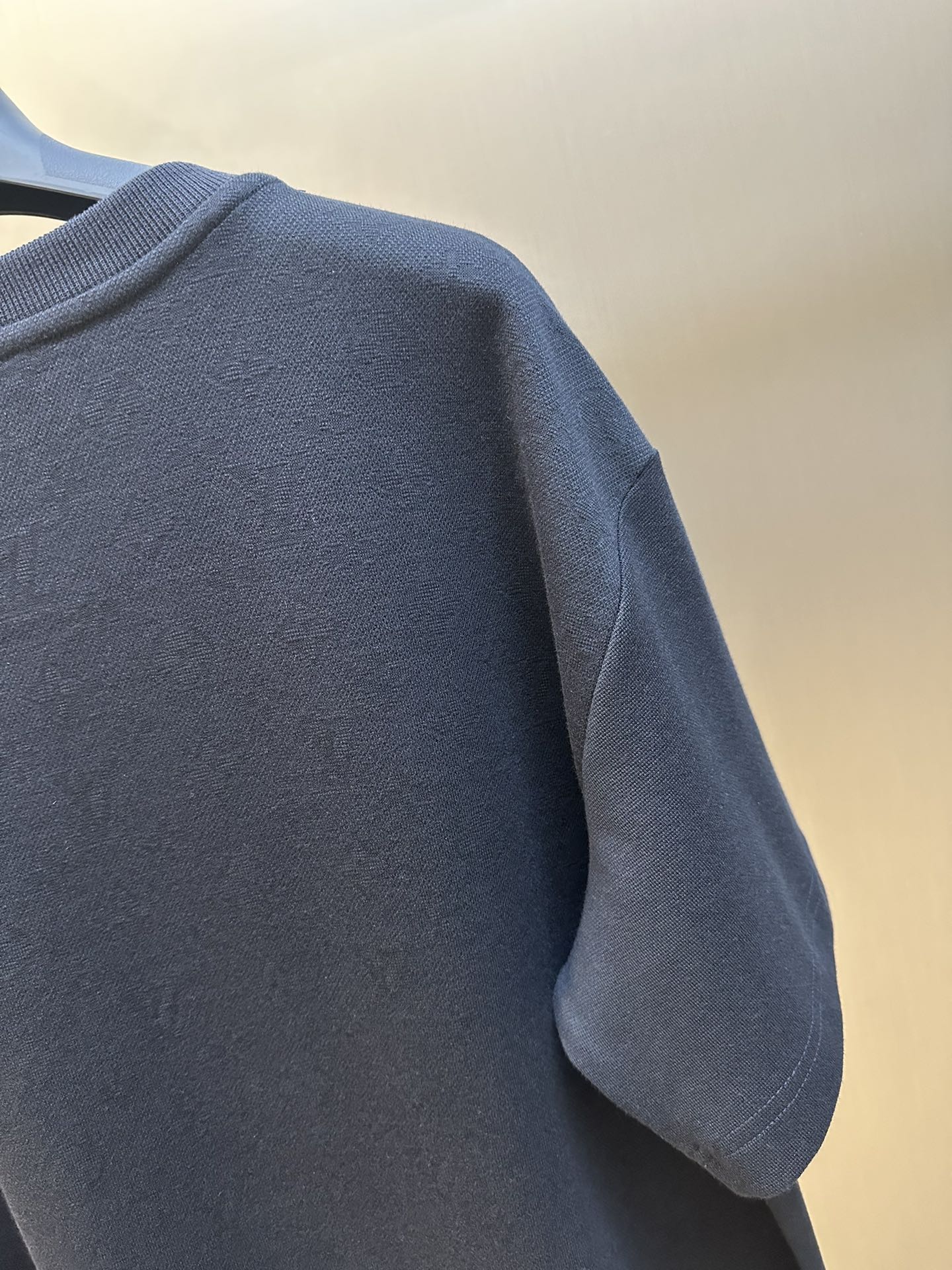 Louis Vuitton dark navy T-shirt sleeve and shoulder seam close-up
