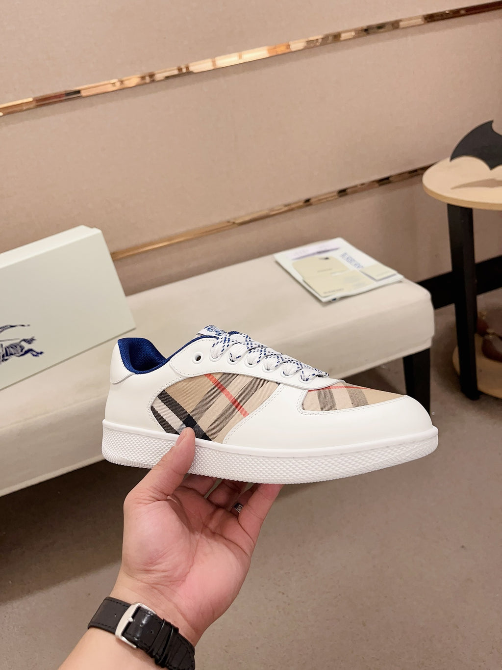 Burberry white low-top sneaker with plaid side panel and blue accent heel
