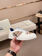 Burberry white low-top sneaker with plaid side panel and blue accent heel