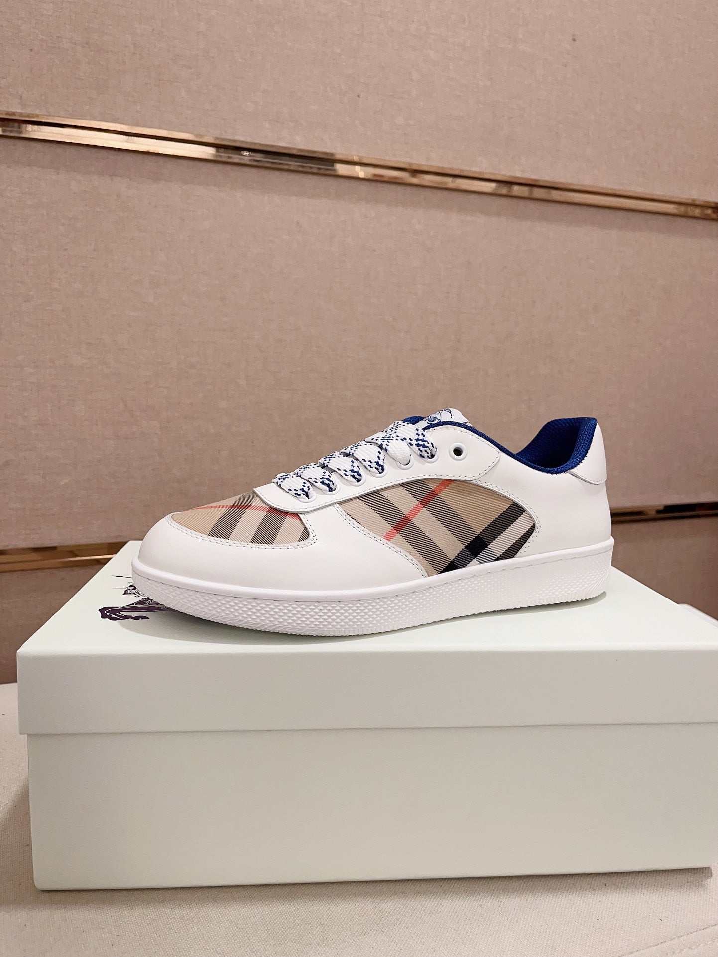 Burberry white low-top sneakers with blue lining, plaid panel, and lace-up closure
