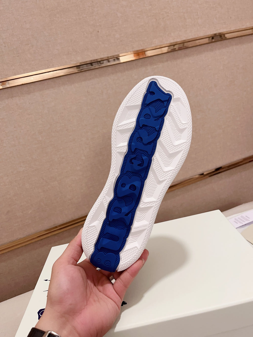 Burberry sneaker outsole with blue traction tread on white rubber sole