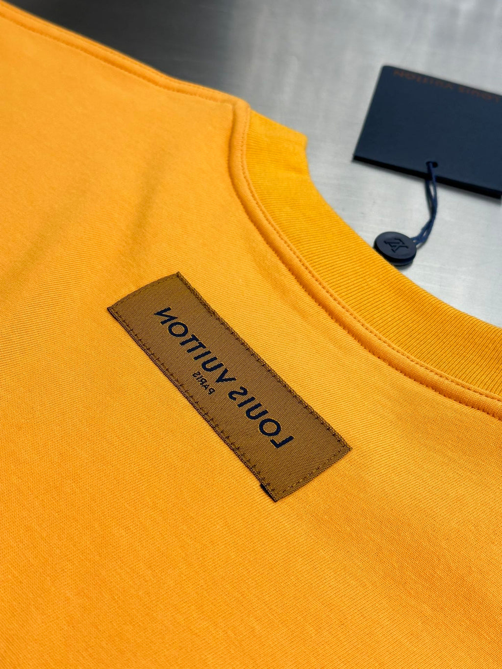 Louis Vuitton yellow T-shirt close-up of front neck label and crew collar