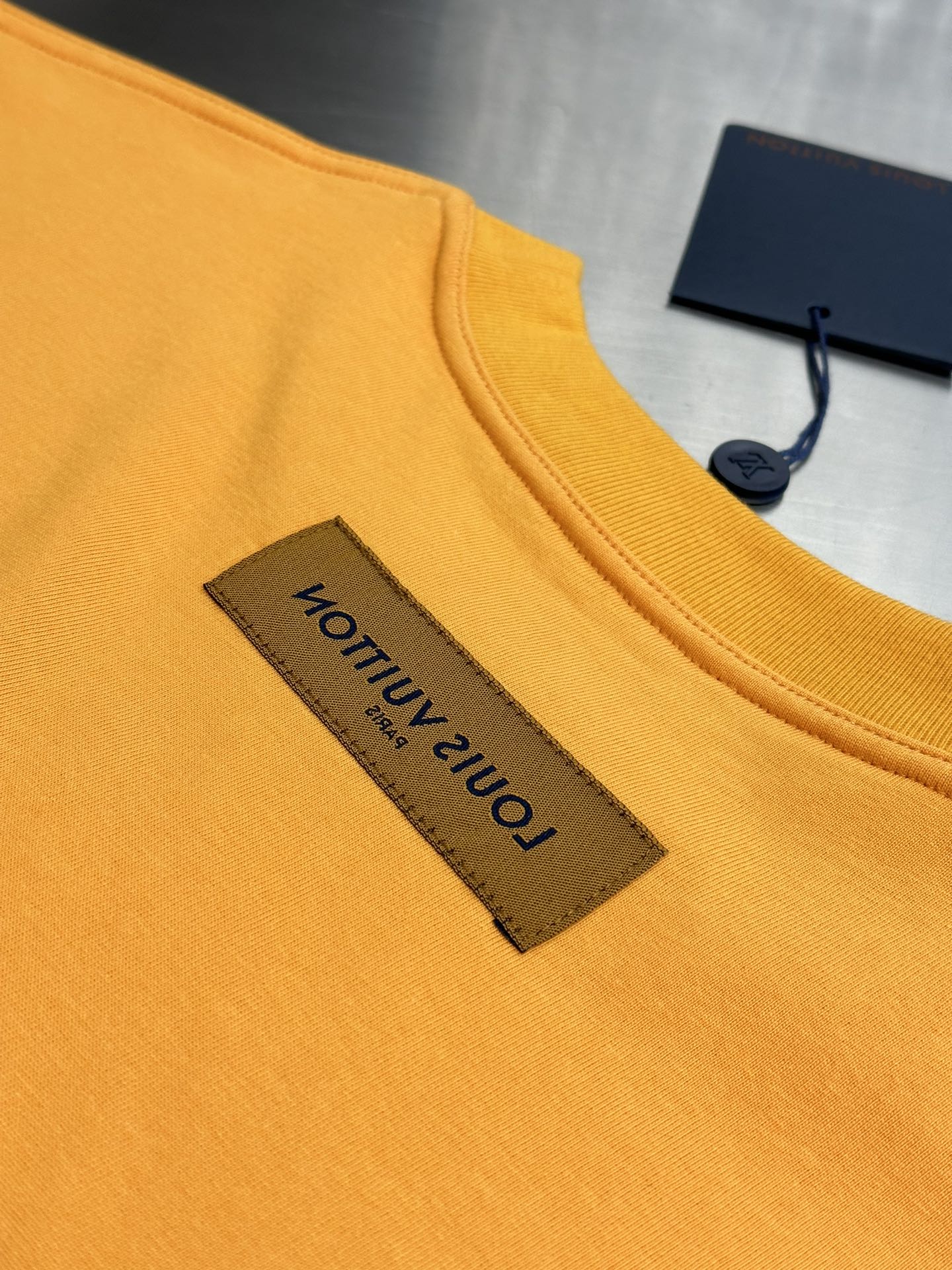 Louis Vuitton yellow T-shirt close-up of front neck label and crew collar