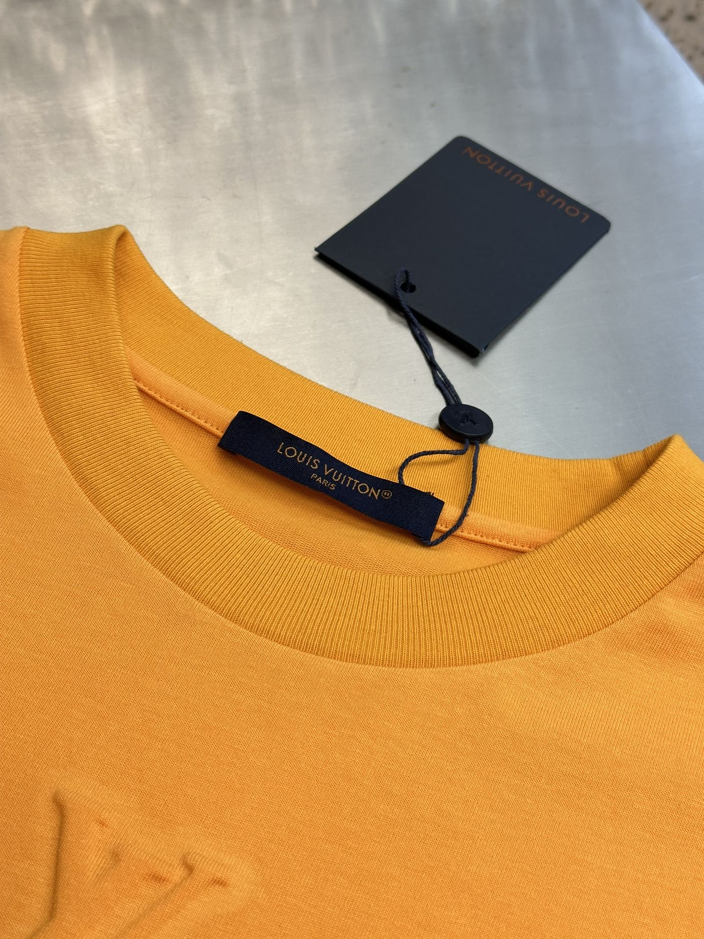 Louis Vuitton yellow T-shirt neckline with hanging brand tags and black trim