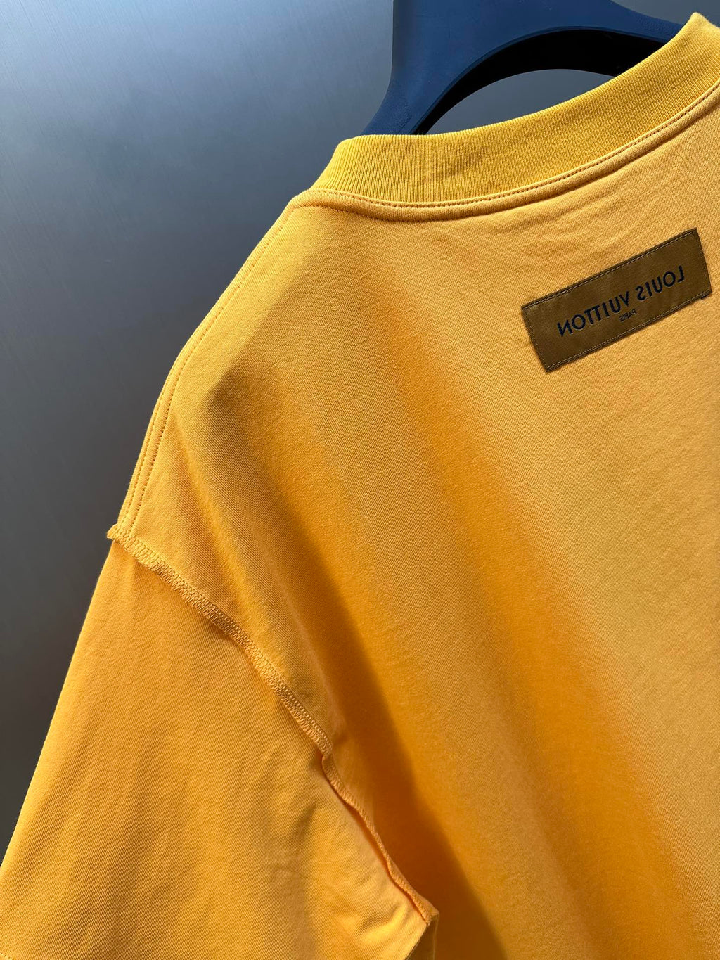 Louis Vuitton yellow T-shirt, close-up of back collar and brand woven tag