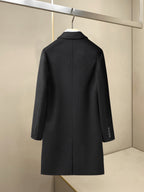 Black long overcoat back view with high collar and buttoned cuffs