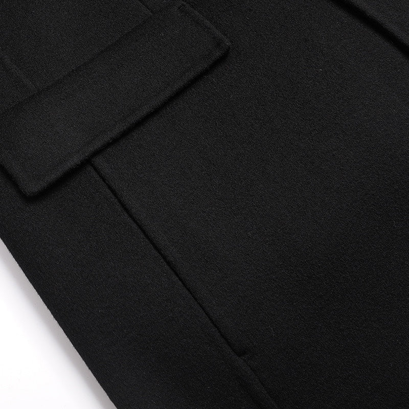 Black coat sleeve cuff with two dark buttons
