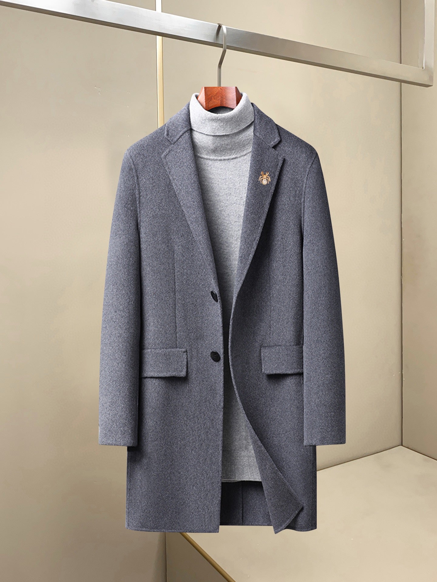 Light gray long wool coat with notch lapels, patch pockets, and small chest pin