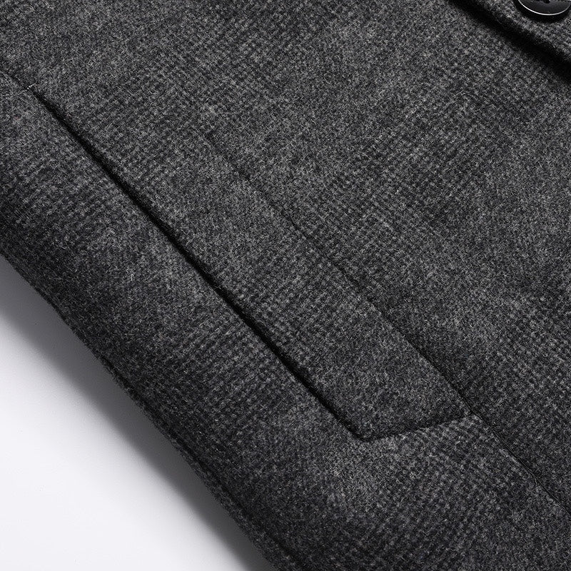 Charcoal coat sleeve with stitched seam detail and textured fabric