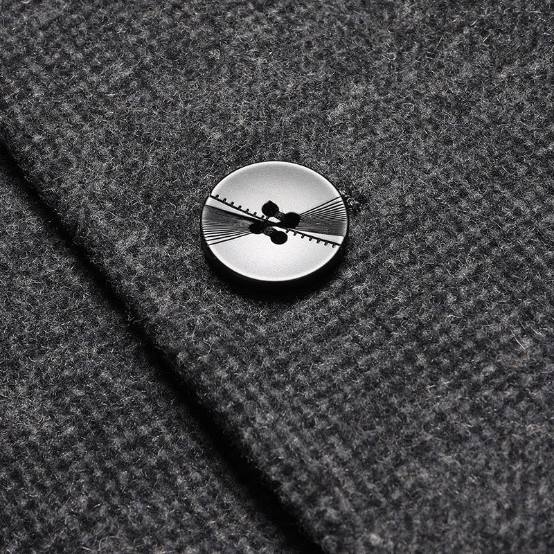 Charcoal coat front button detail with four-hole design