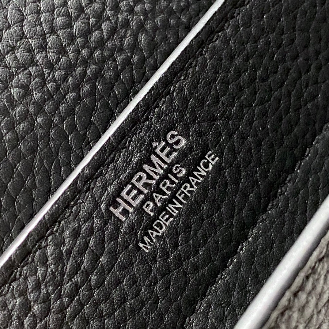 Hermes bag leather stamp reading “HERMES PARIS MADE IN FRANCE” on black grain.