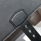 Hermes bag front leather close-up with strap slot and three metal rivets.