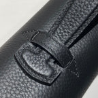Hermes bag leather close-up with stitched strap keeper and metal buckle detail.