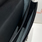 Hermes bag interior close-up with dark lining and attached strap inside the frame.
