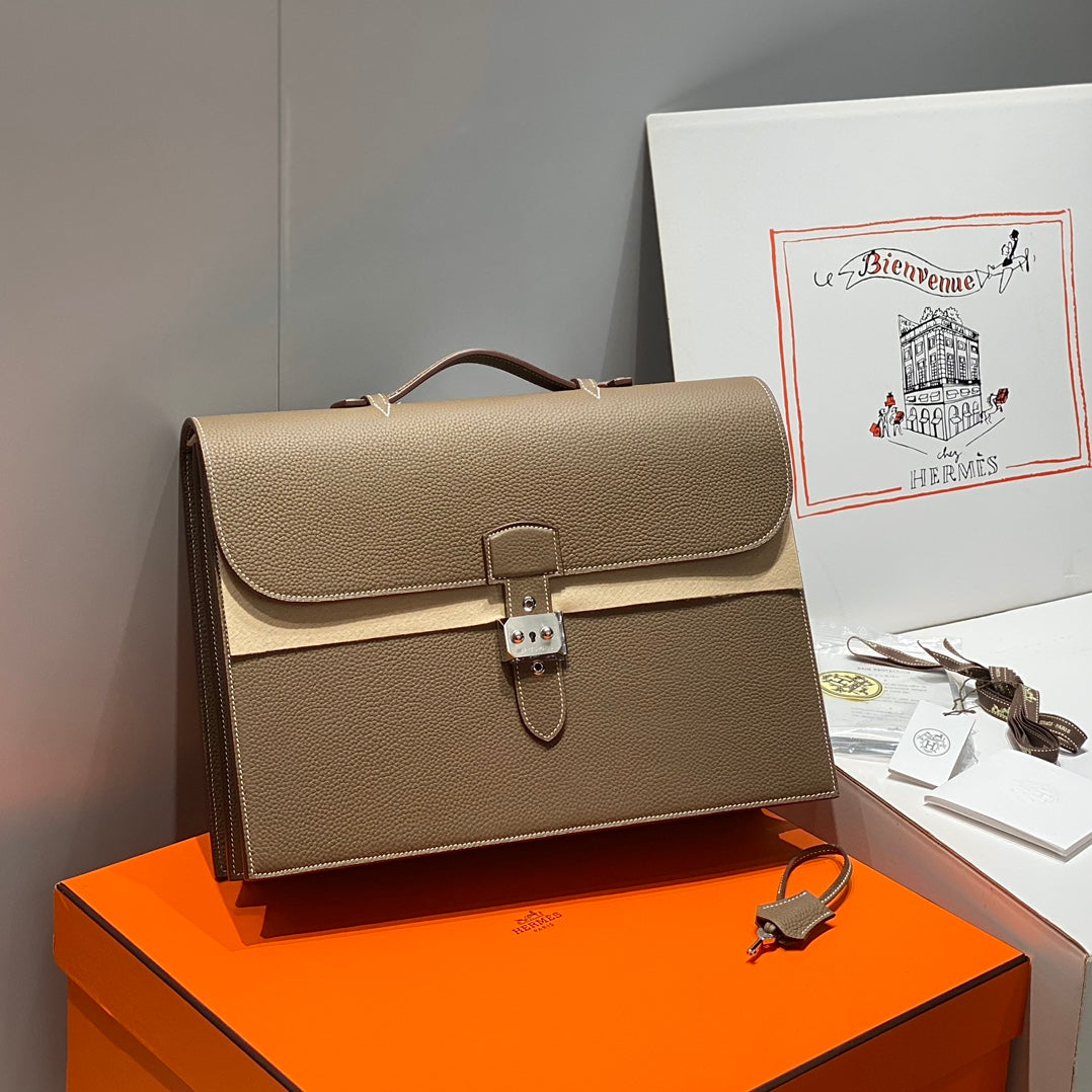 Hermes structured leather briefcase with front flap, top handle, and lock clasp