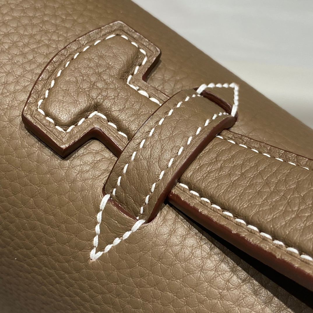 Hermes leather flap closure with stitched tongue and embossed H detail