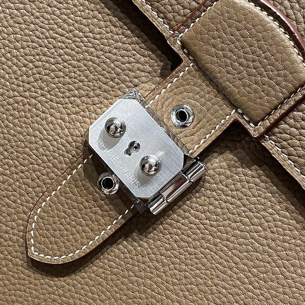 Hermes leather strap hardware with silver-tone clasp plate and stitched edge