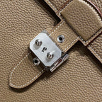 Hermes leather strap hardware with silver-tone clasp plate and stitched edge