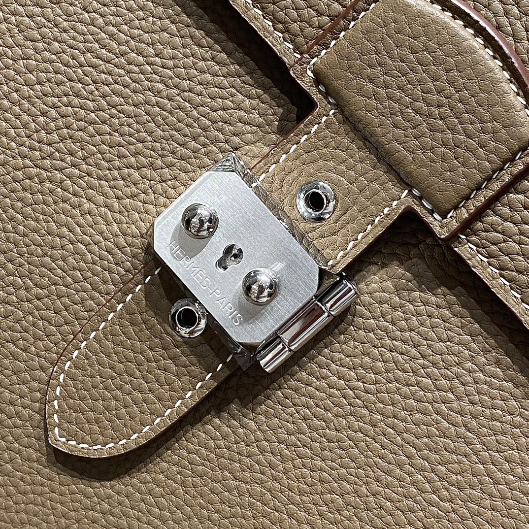 Hermes leather strap hardware with silver-tone clasp plate and stitched edge