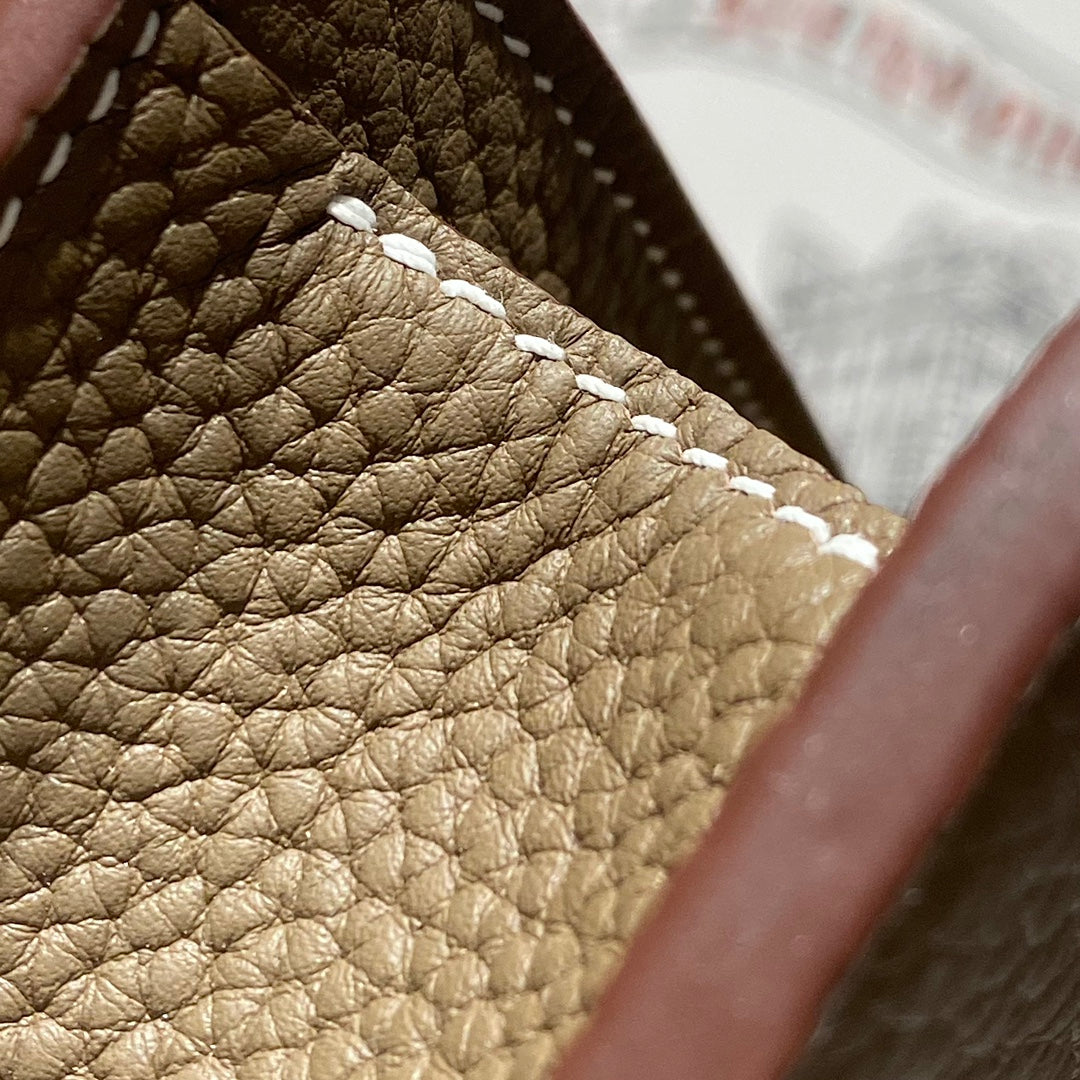 Hermes quilted leather lining with stitched edge and brown trim