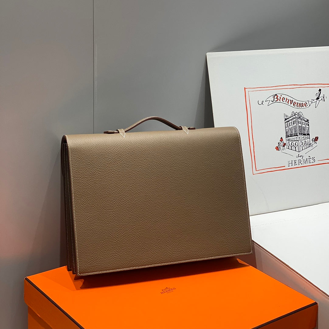 Hermes structured leather handbag with top handle and front flap