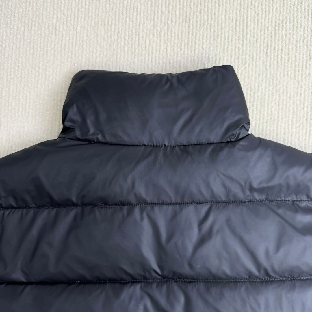 Moncler hooded puffer jacket, dark navy, raised collar and quilted front close-up