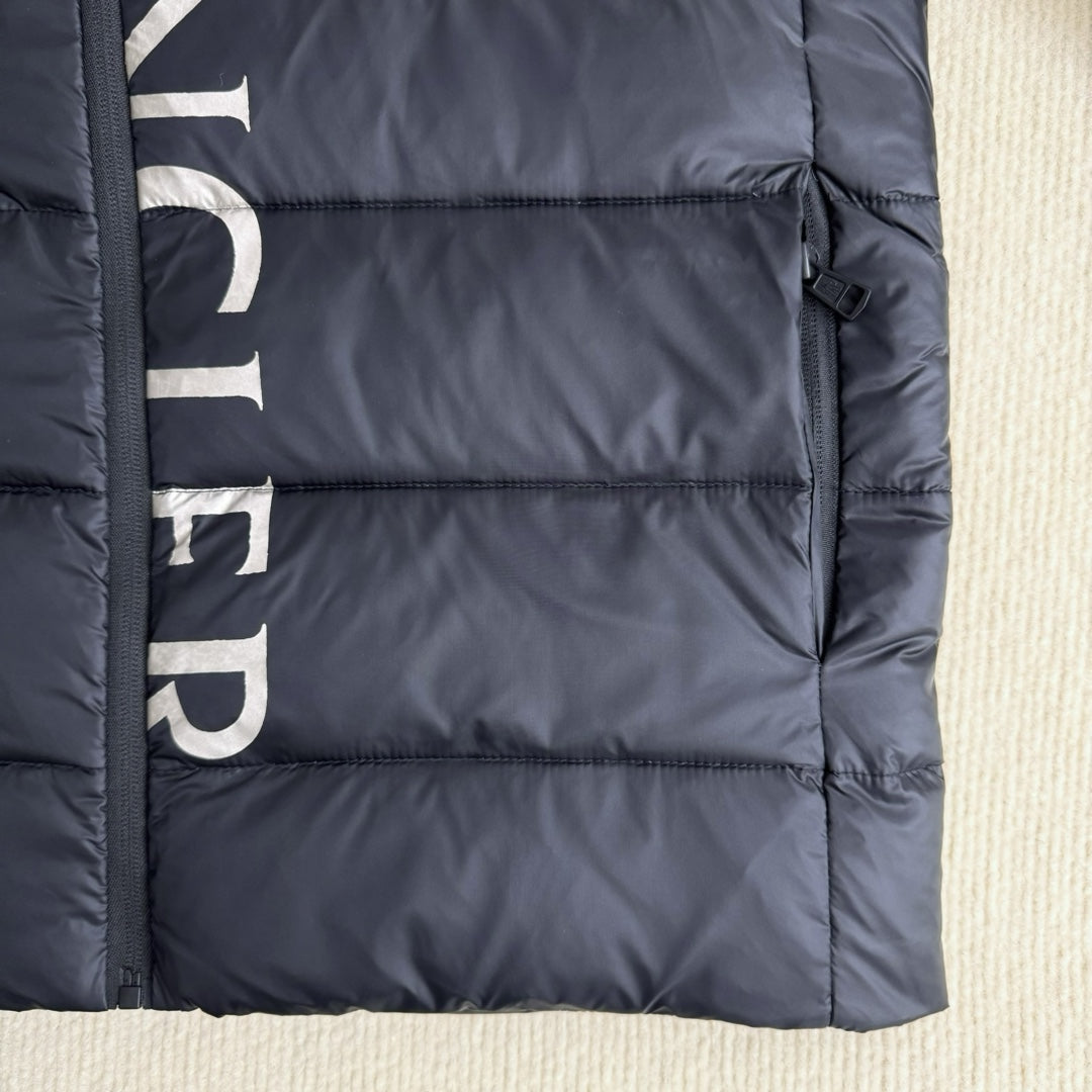 Moncler long puffer jacket bottom hem detail, dark navy quilting and zipper side