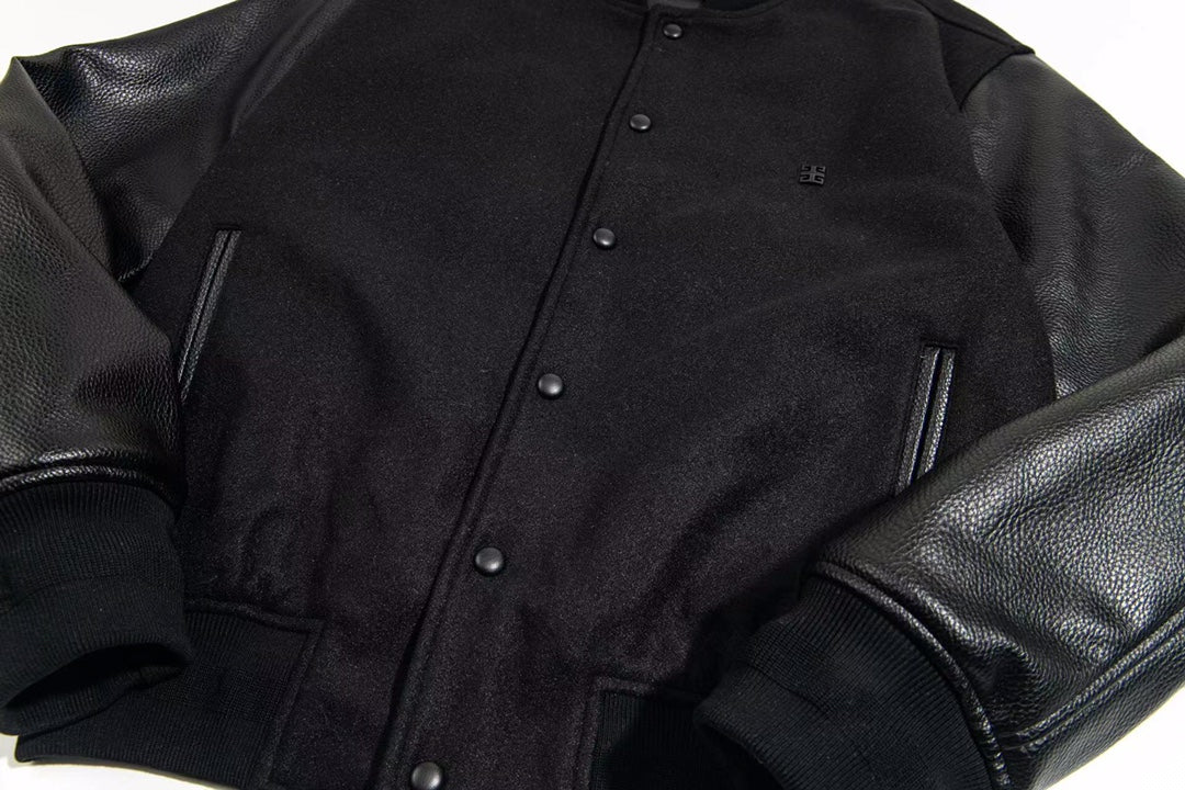 Black snap-front varsity jacket with zip pockets and leather-look sleeves