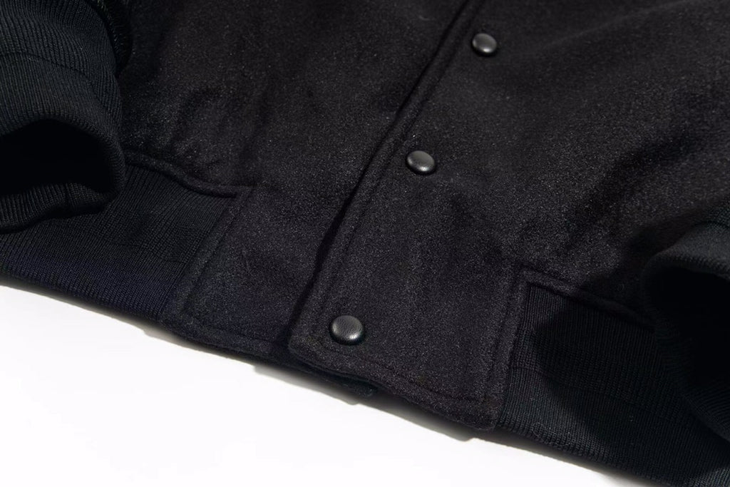 Givenchy dark jacket front with snap buttons and ribbed cuffs