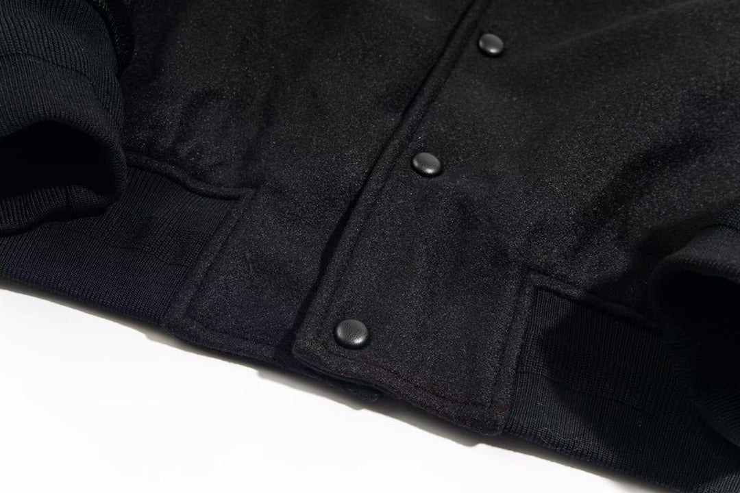 Givenchy dark jacket front with snap buttons and ribbed cuffs