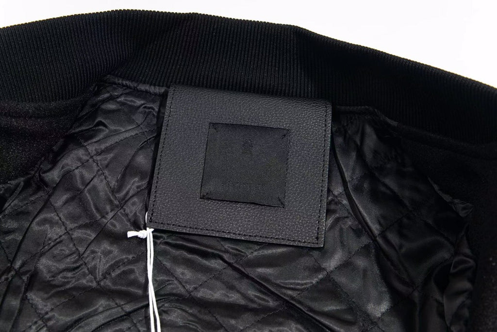 Black inner neck label on varsity jacket collar with ribbed knit trim