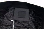 Black inner neck label on varsity jacket collar with ribbed knit trim
