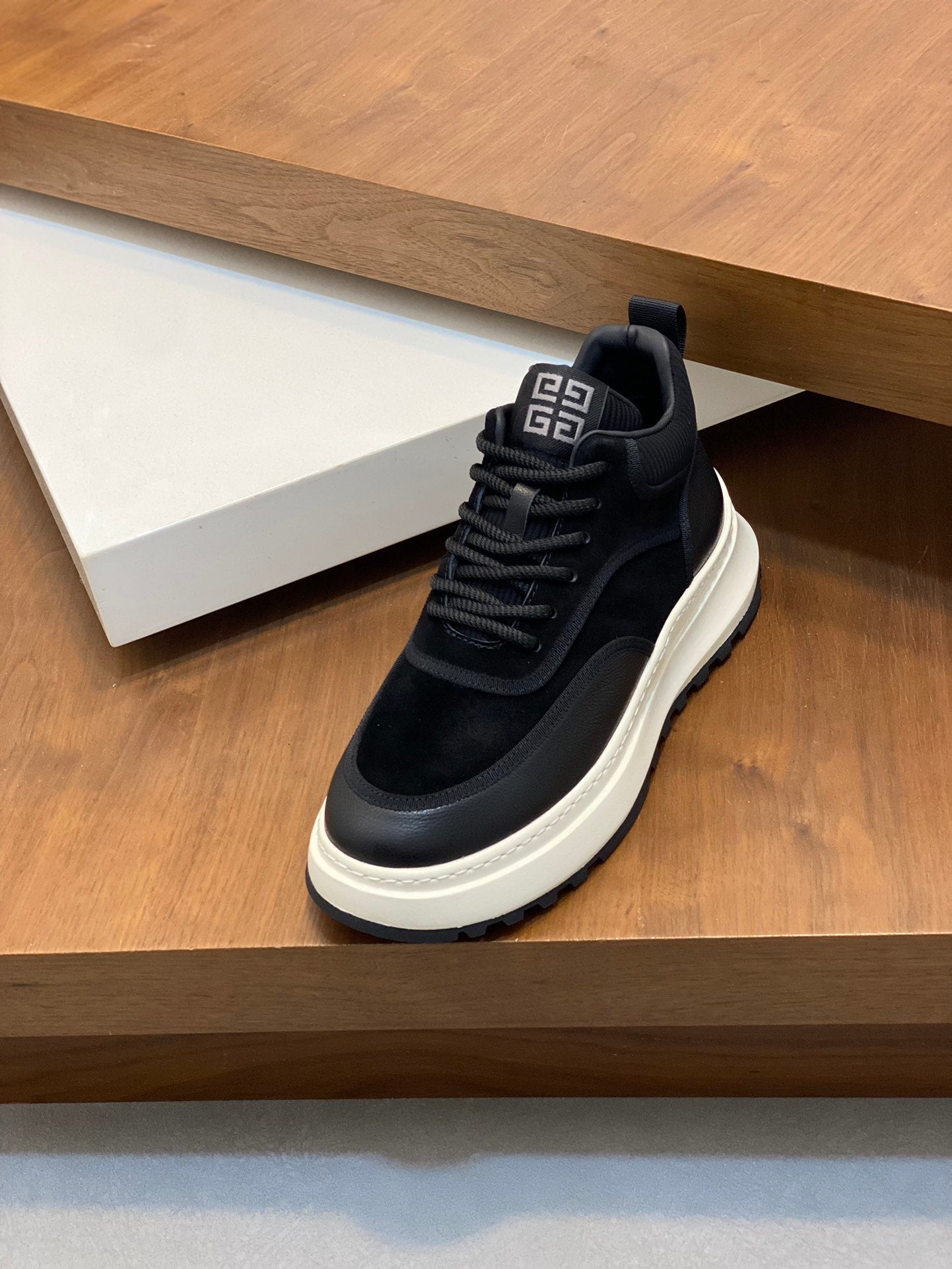 Black lace-up sneakers with cushioned collar and white platform sole