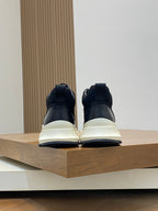 Black and white sneakers, back view with padded heel and thick sole