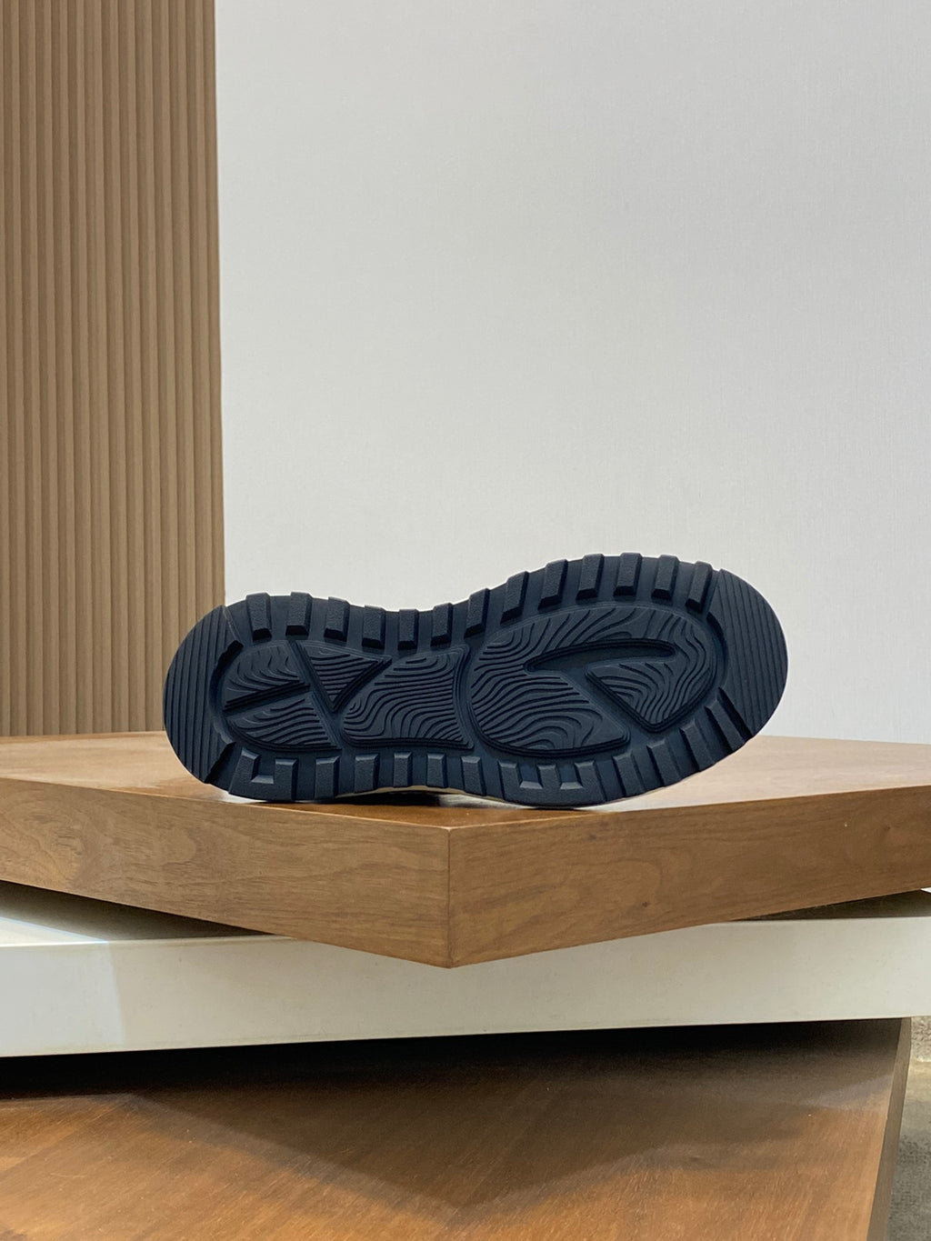 Shoe outsole detail with dark rubber tread and white midsole edge