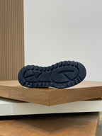 Shoe outsole detail with dark rubber tread and white midsole edge