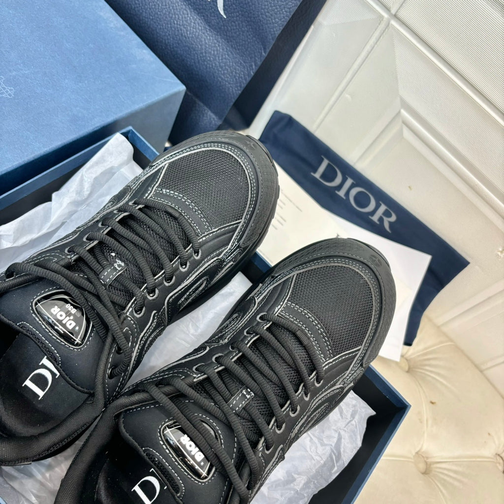 Dior unisex sneakers close-up, dark grey uppers with laces and logo detail on tongue